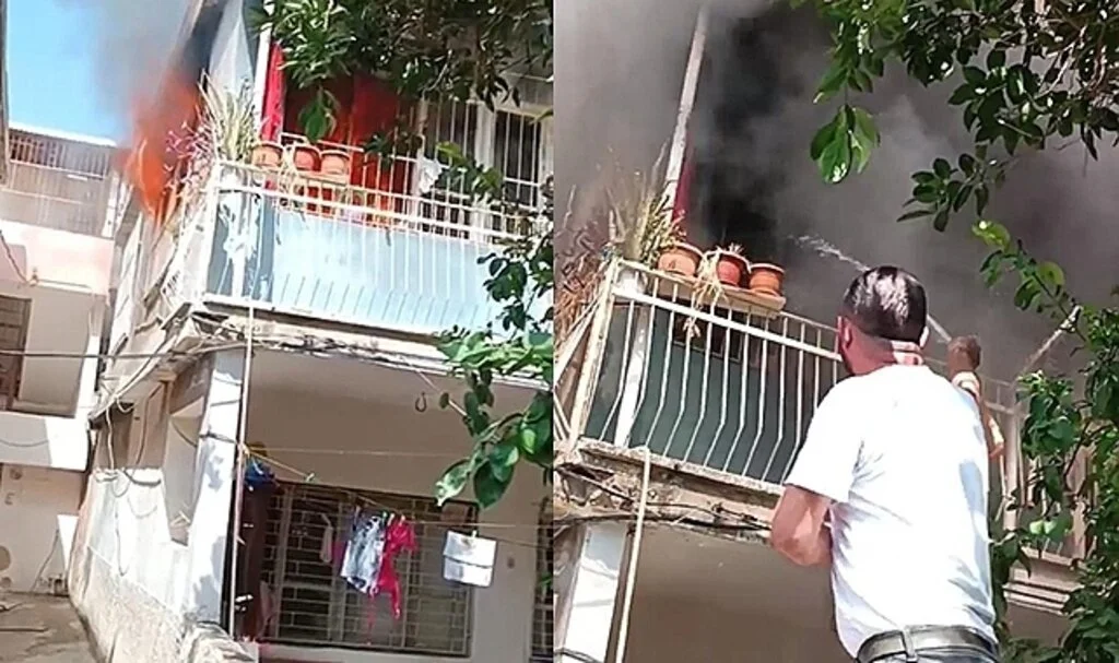 Yanan evi hortumla söndürmeye çalıştı